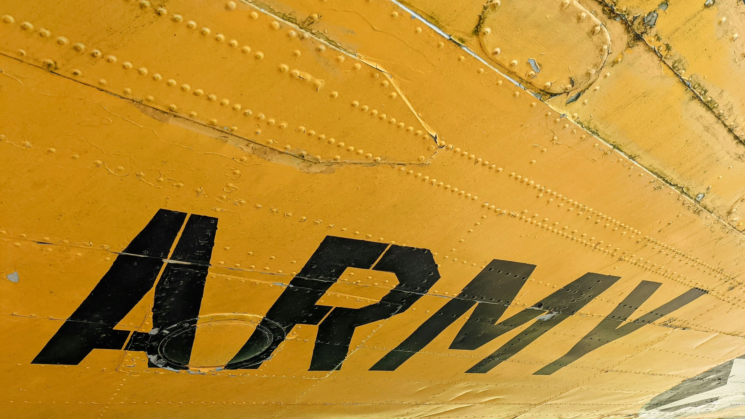 a large yellow airplane has an army logo