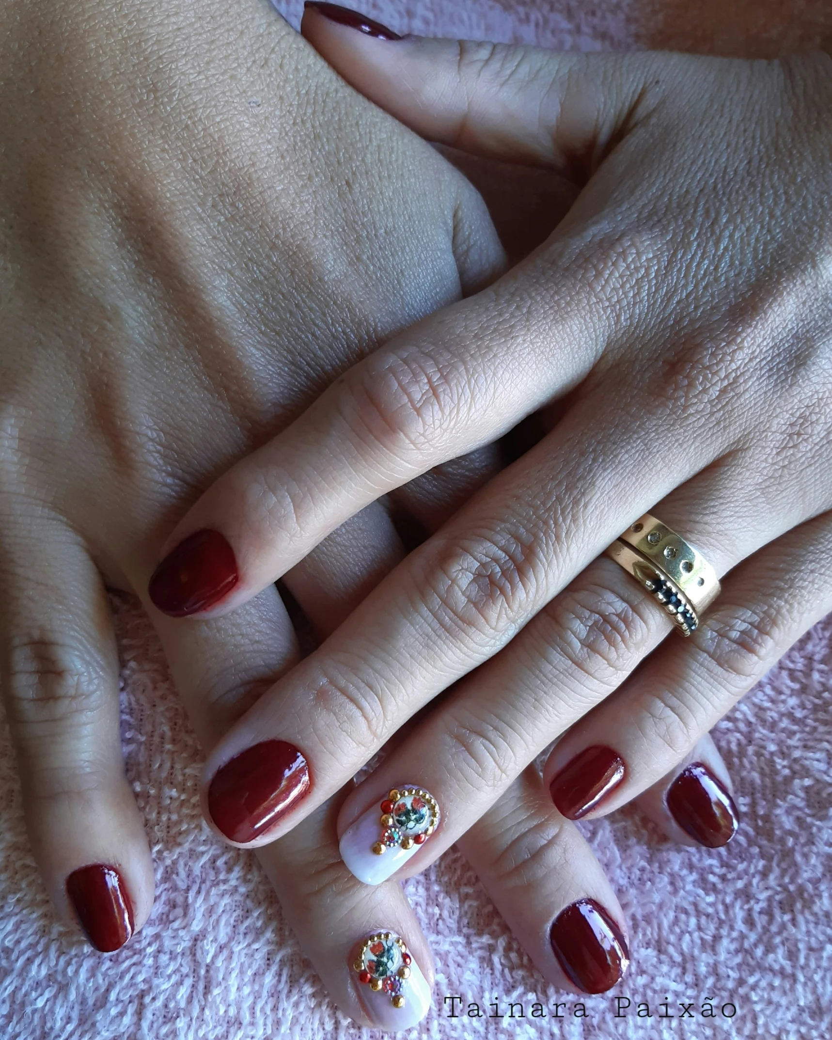 two hands that are on top of a pink towel