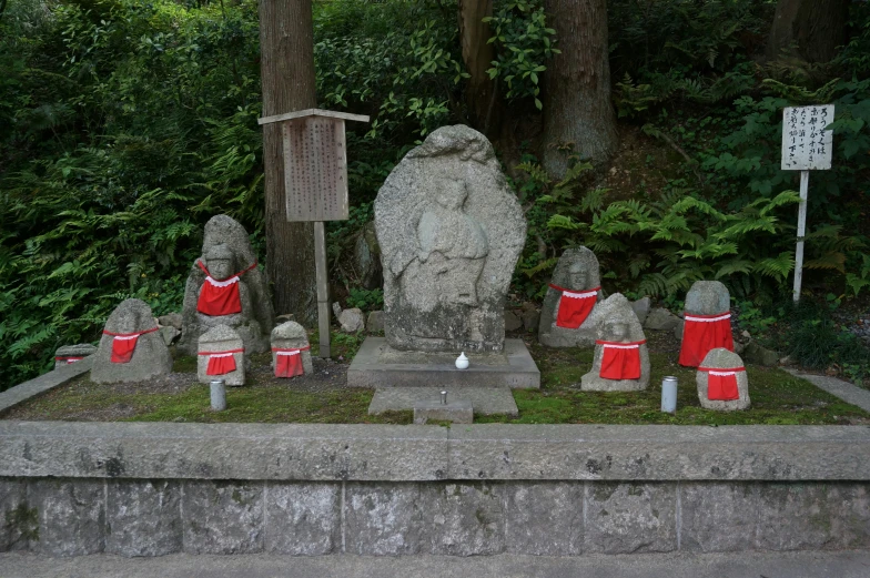 a group of statues in front of trees