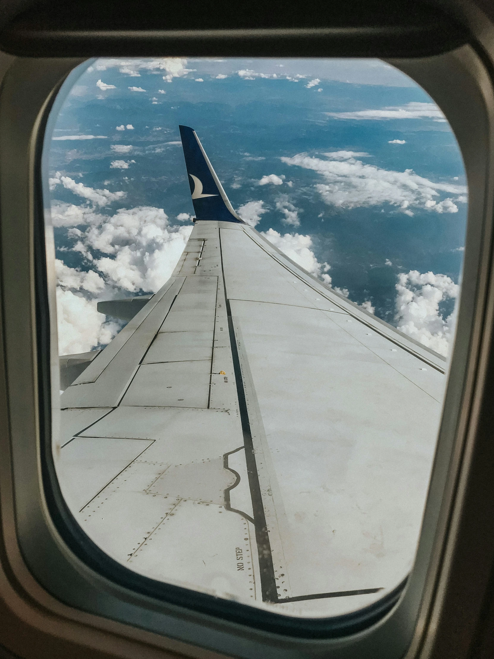 the view from inside an airplane shows the wing of the plane