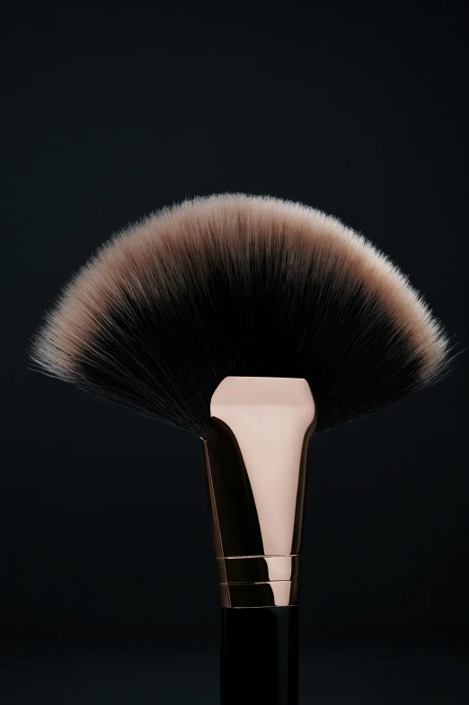 a large black brush is in front of a dark background