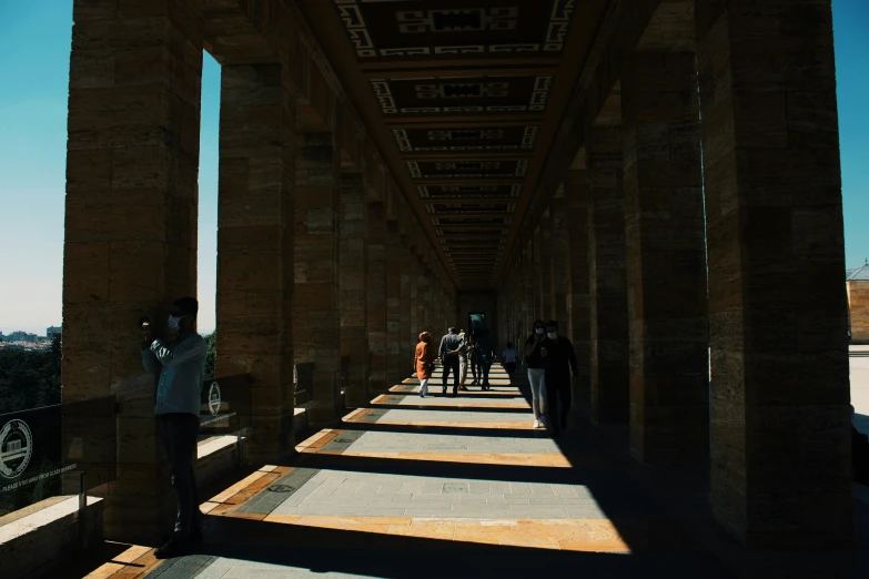 people walking in the same direction on an underpass