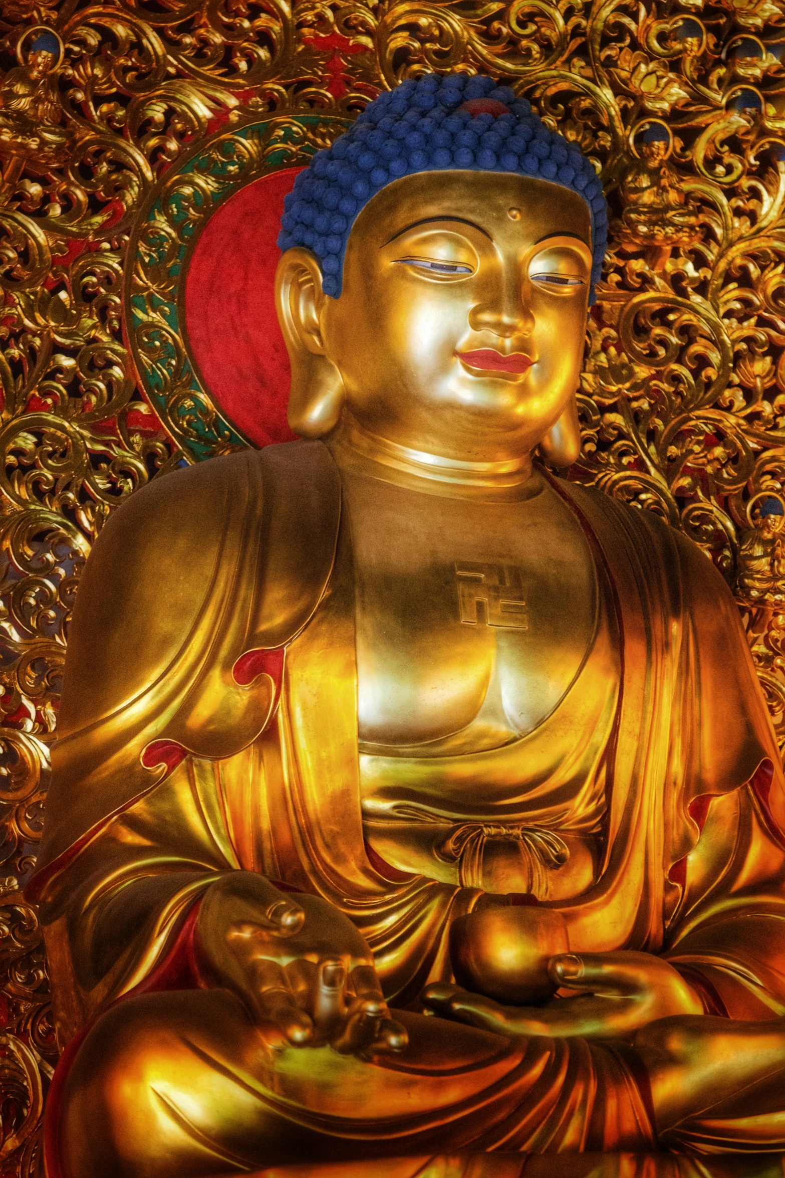 buddha statue surrounded by gold leaf like chains