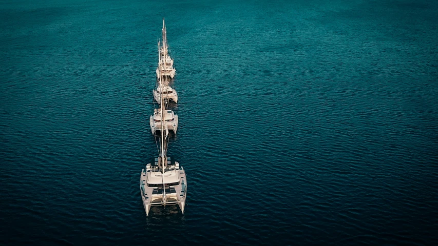 several boats in the ocean near each other