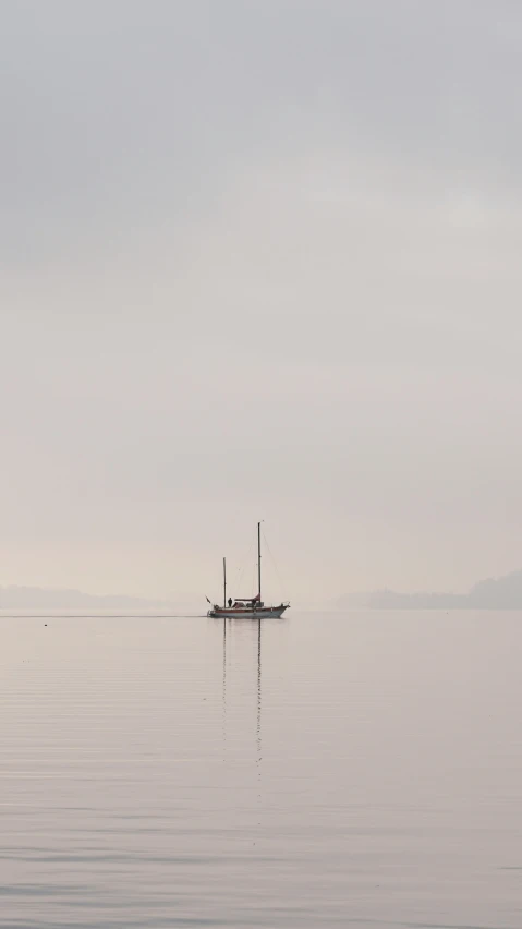 an old boat sailing on water near shore