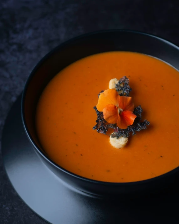 a bowl of soup with carrots and ers in it