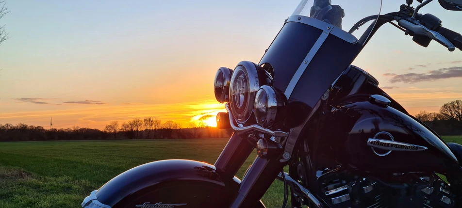 sunset reflecting off of the front of a motorcycle