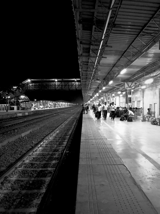 black and white po of people at train station