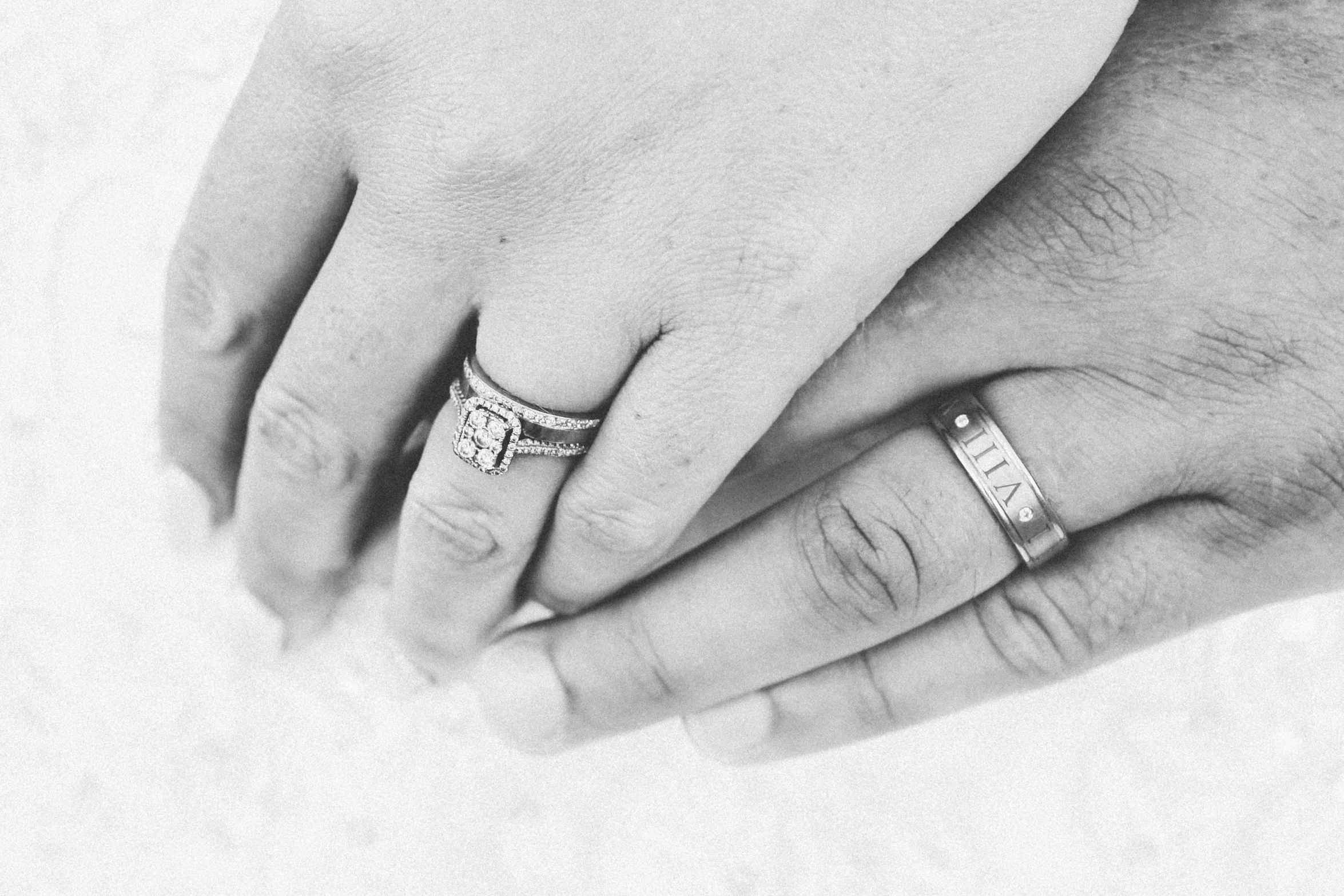 a close up of two people holding hands