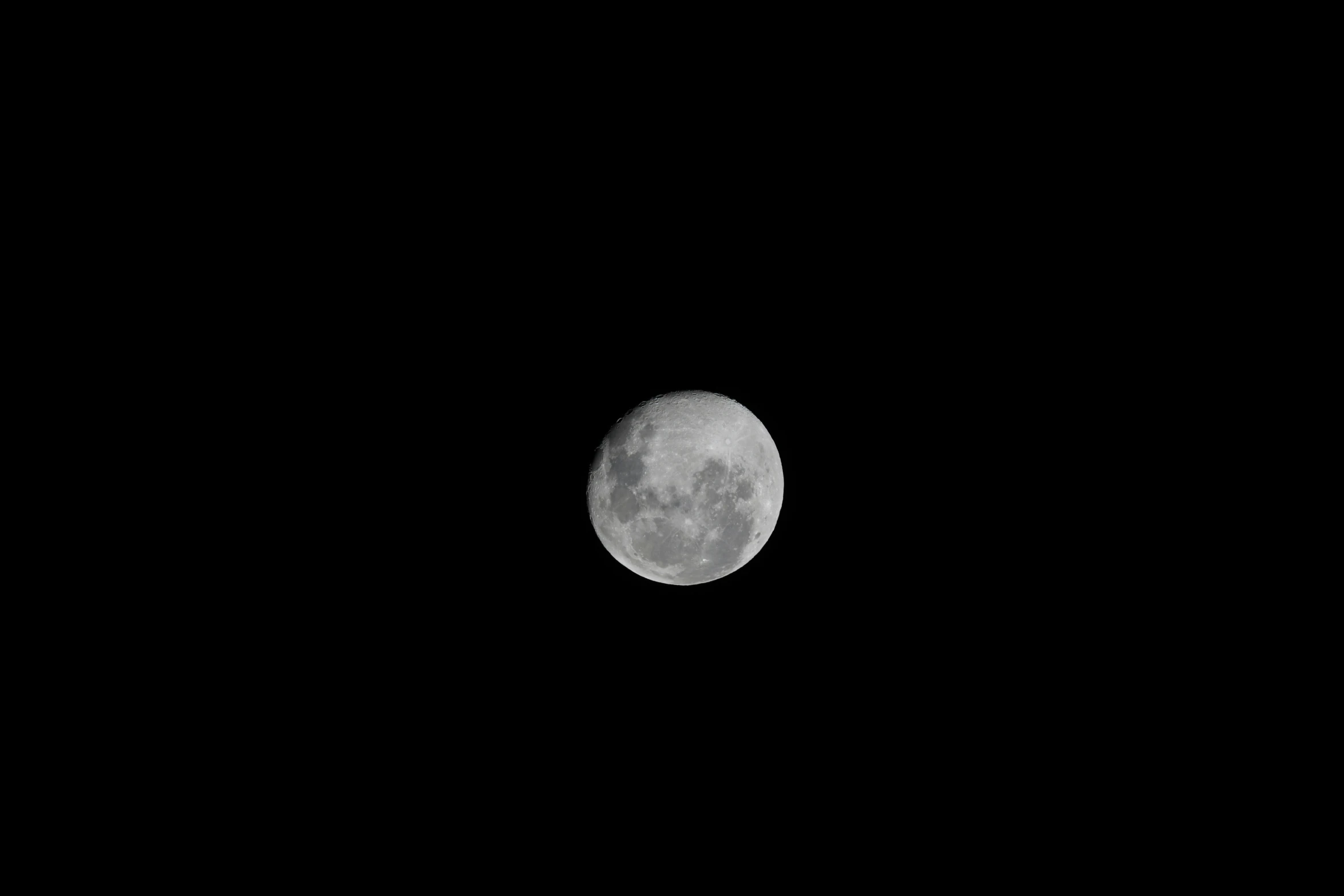 the moon, in the dark night sky