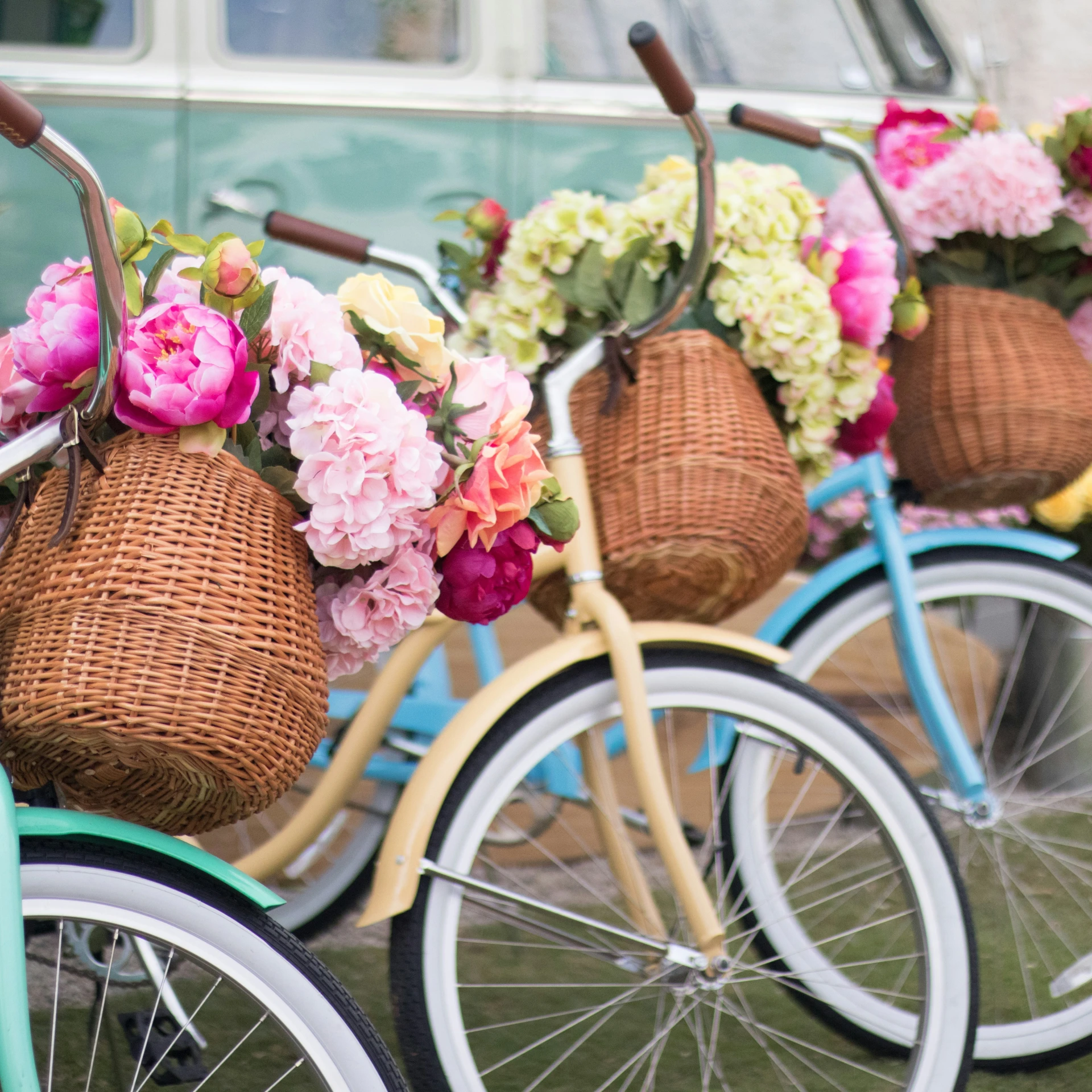 flowers are sitting in baskets on bikes parked