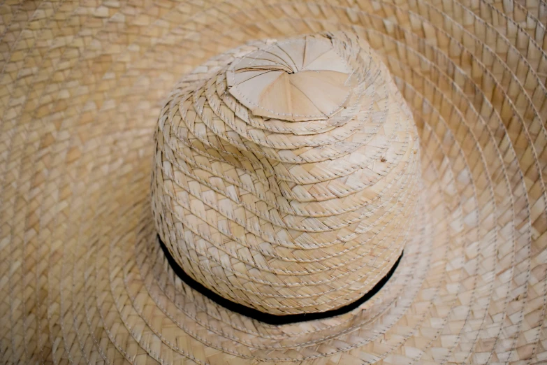 a large hat that is inside a straw
