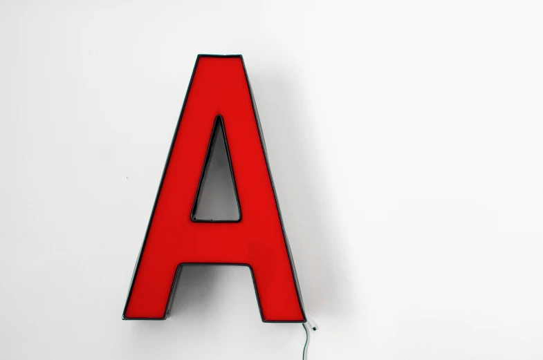 the letters are very red against a white wall
