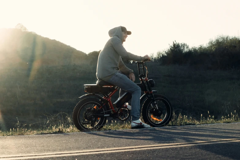 a man riding a bike on the side of a road