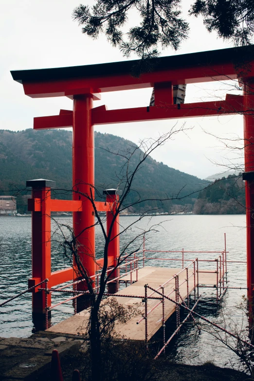 a boat dock with an orange tori tori in the background