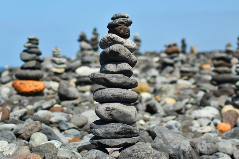 a pile of rocks that are stacked in the middle of a field