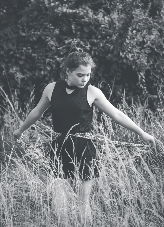 a child playing in the grass with a stick