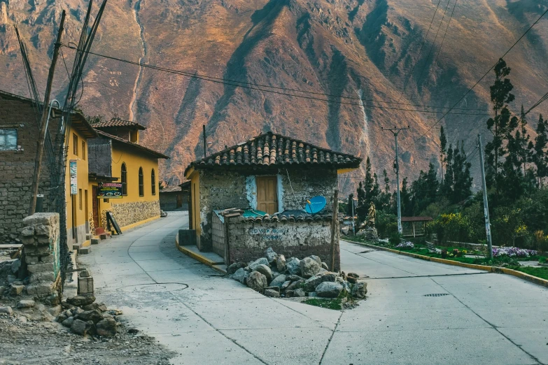 small houses nestled among the mountains near a road