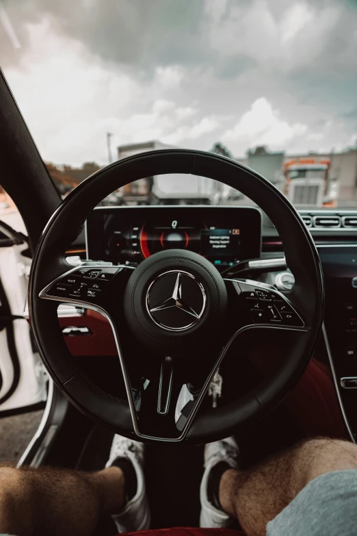 a car dashboard is shown with a man sitting behind it