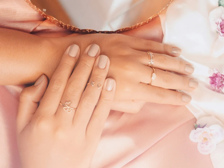 woman's hand with multiple jewelry ring laying on her arm