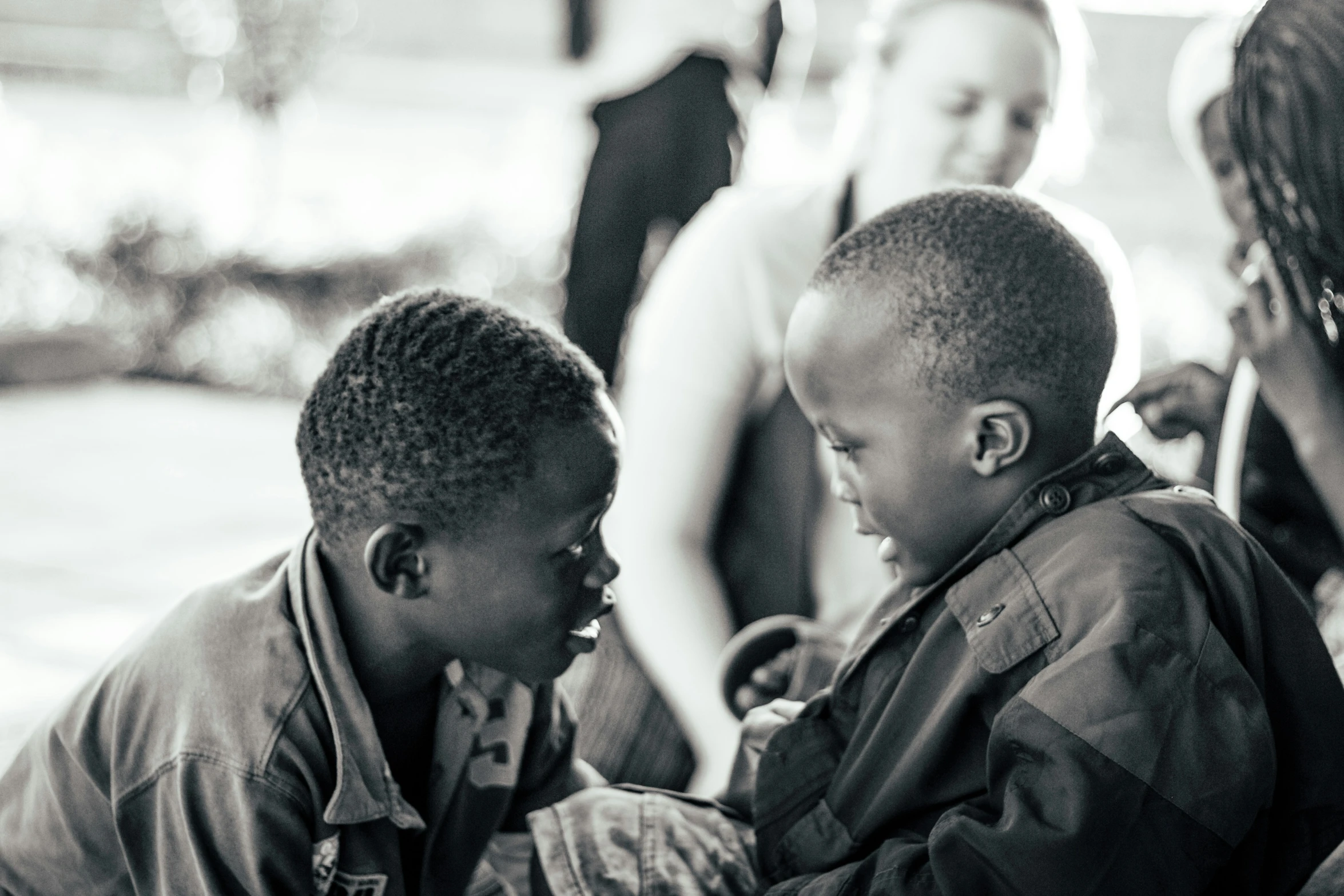 a group of young men sitting around each other