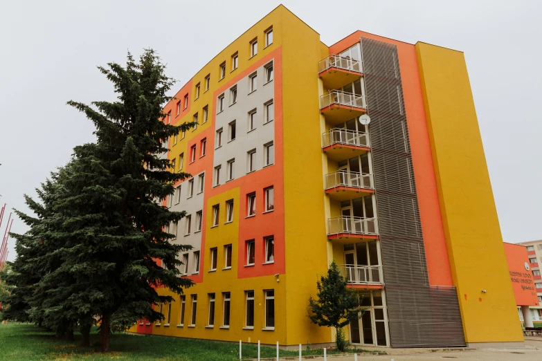 there is an orange and yellow building on the street