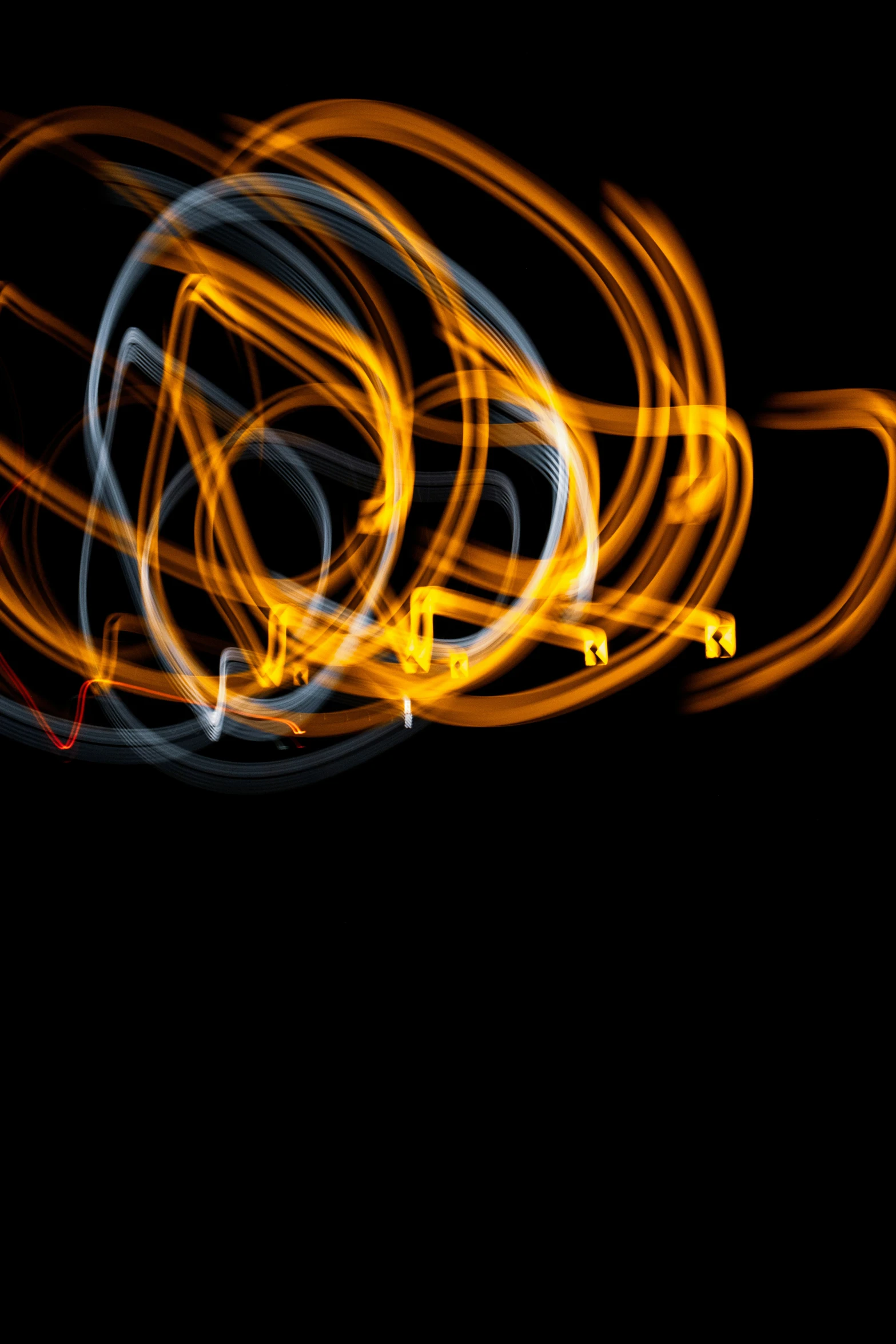 a couple of orange and white swirls against a black background