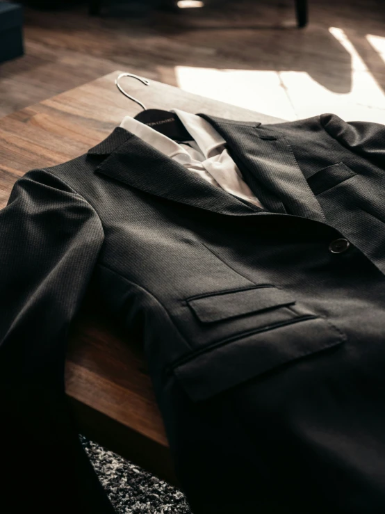 a shirt with tie sits on a table in front of a mirror