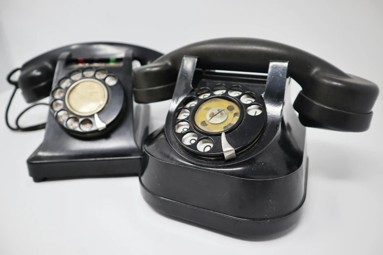 there is a black and gold telephone on this desk