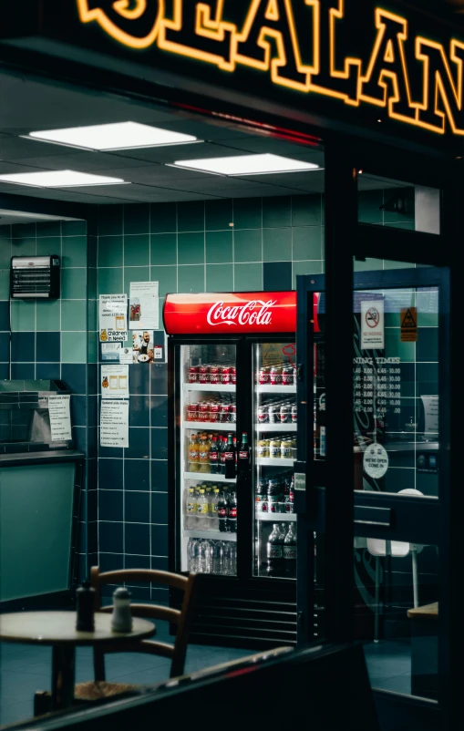 a deli display with two soda machines outside