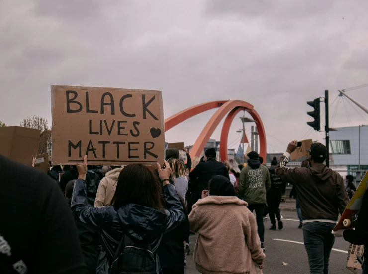 people are walking with signs in a protest