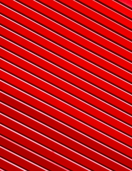 a red, wavy material has a bright green background