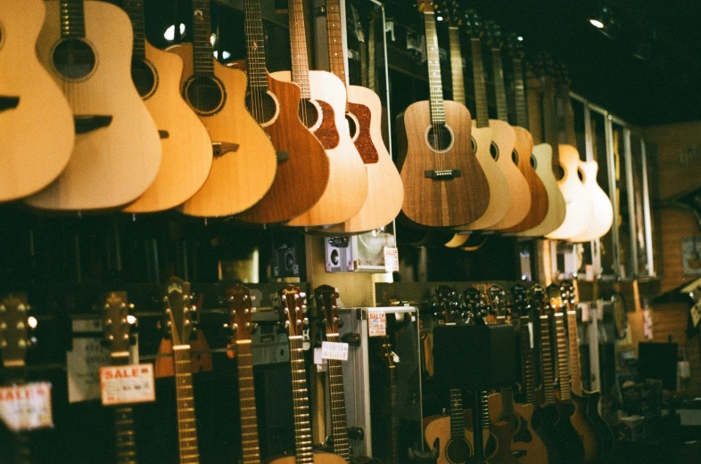 a room with guitars hanging in different shapes