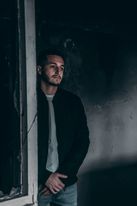 a man standing outside a window at night