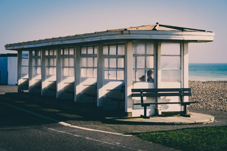 a small white shelter on a sandy beach