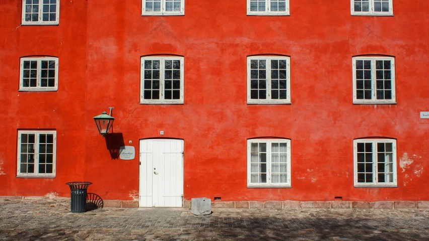 the exterior of a red building with windows