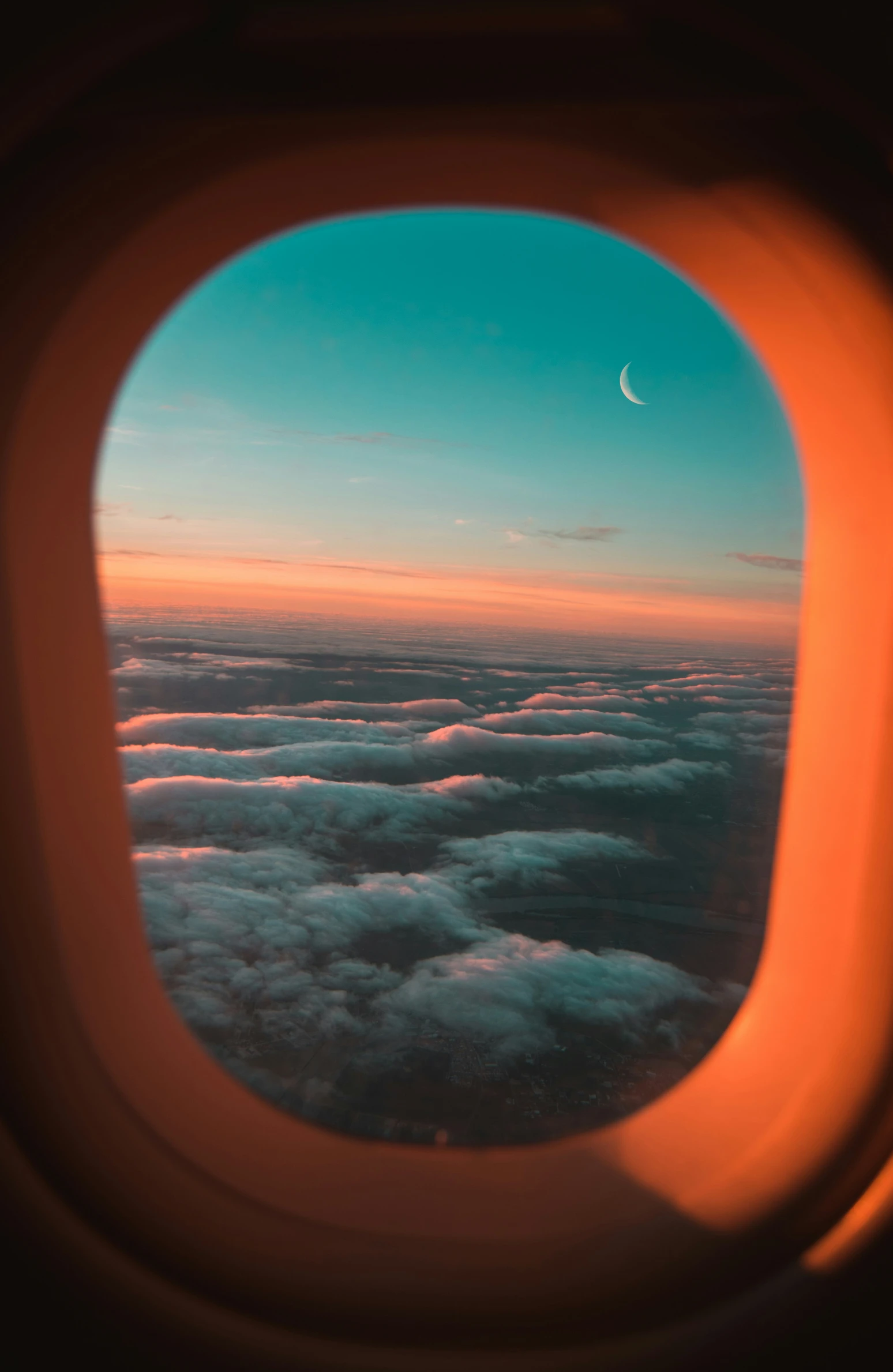 the view from the window of an airplane flying over the clouds