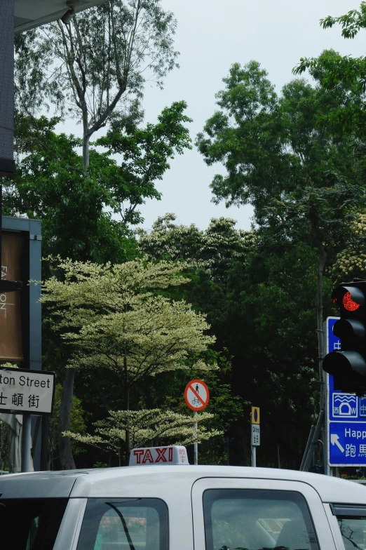 a white truck driving down a street next to traffic signs