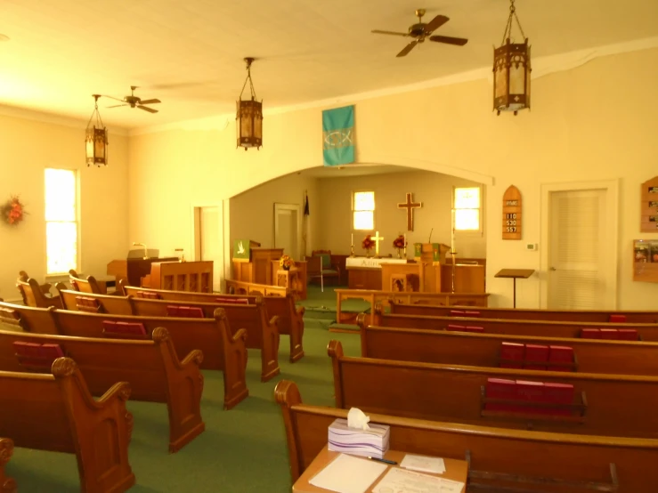 a church with wooden pews and green carpet