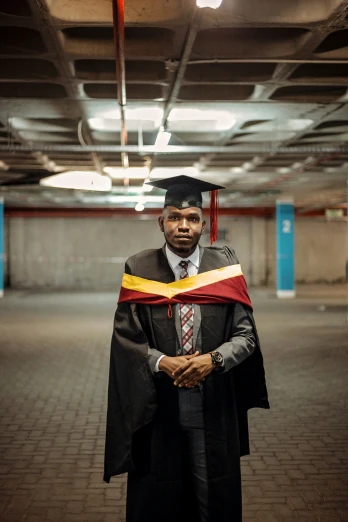 a man is posing with his graduate gown