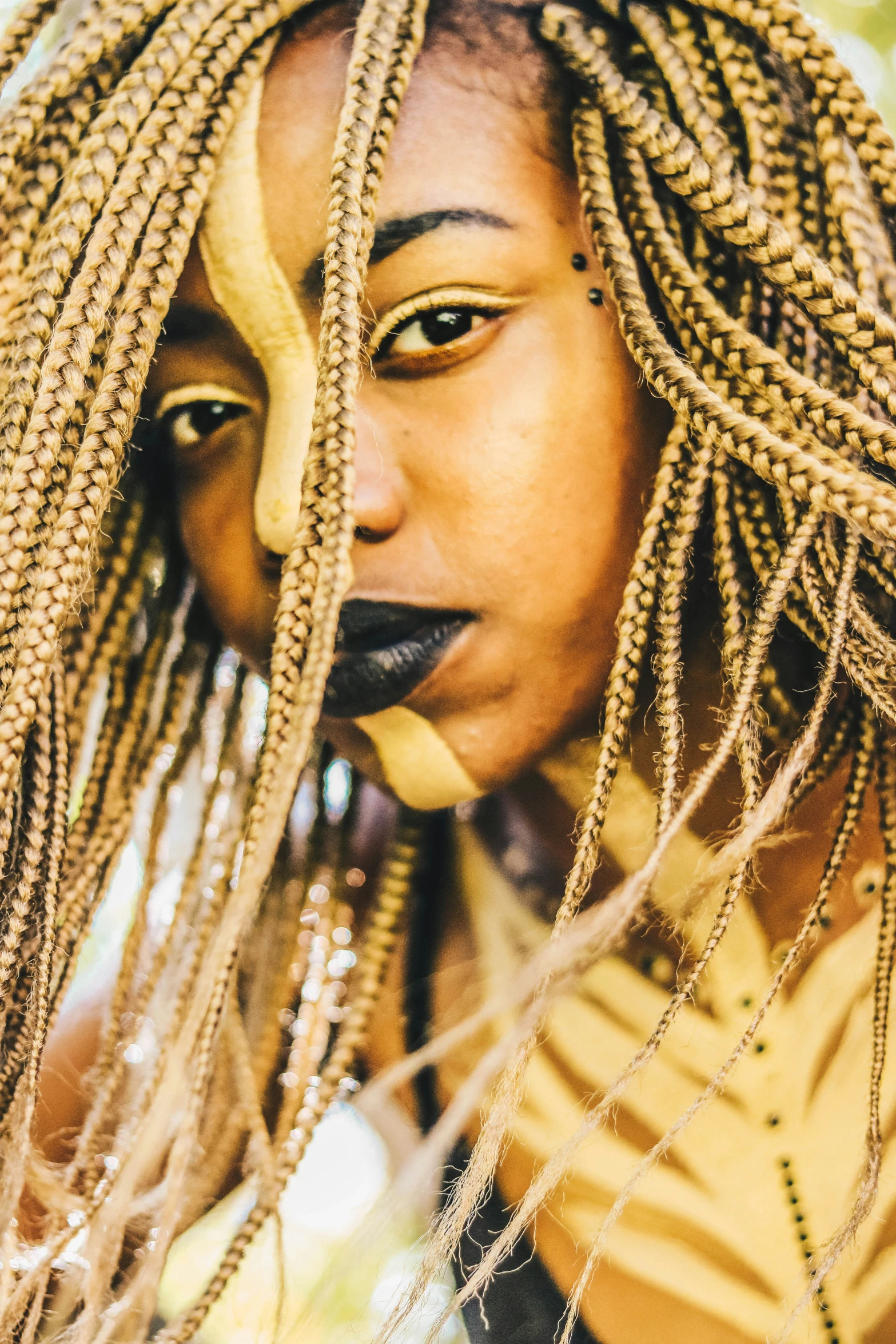 a close up of a person with large dread locks