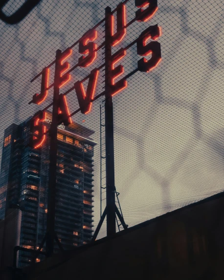 a cross and the words jesus saves written in neon lights on top of a building