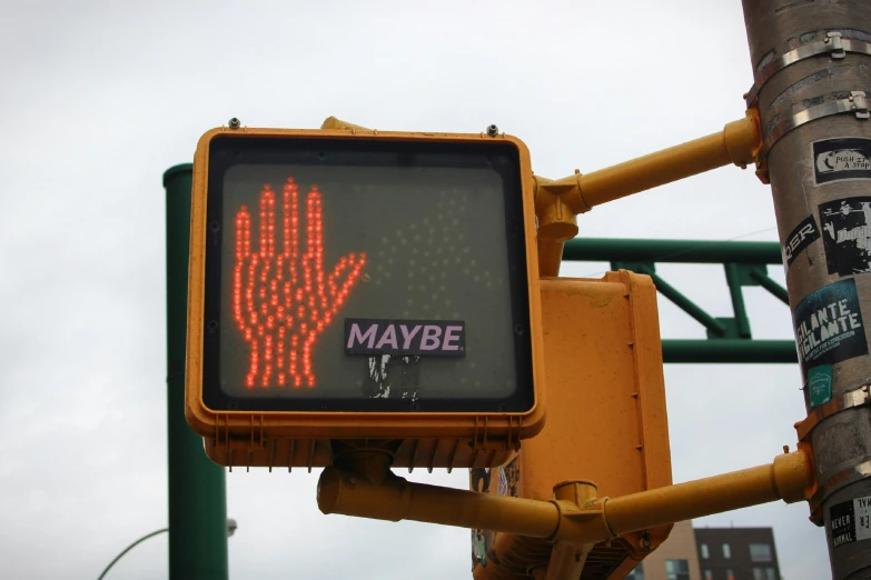 a traffic signal has an image of a hand crossing