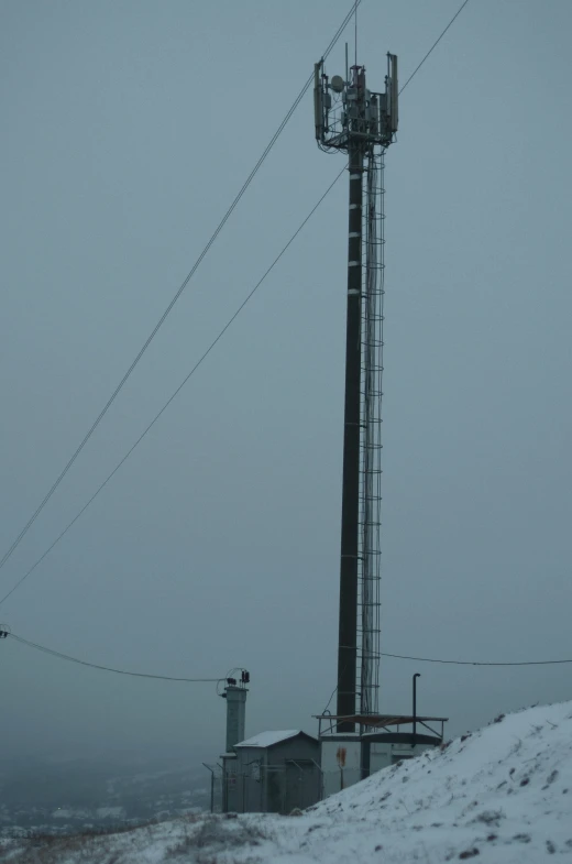 the pole on top of the snow - covered hill with the light