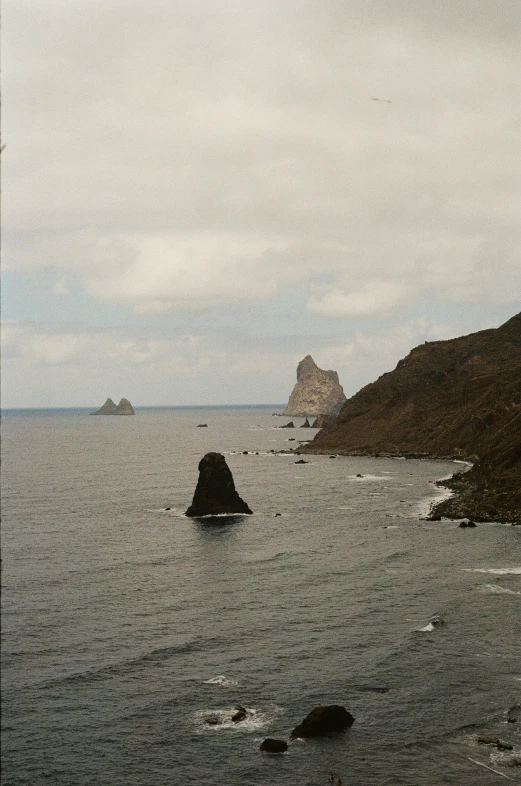 an image of a mountain on the ocean with water