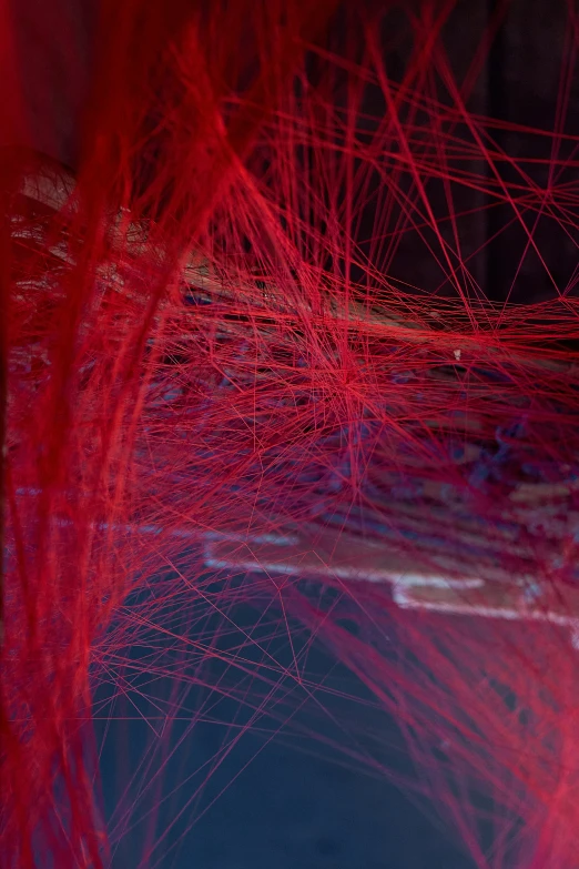 red thread hanging from a ceiling