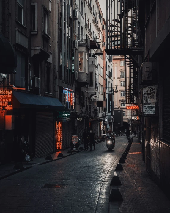 a city street with an alley lined with buildings