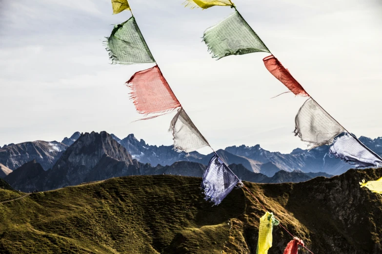 the colorful kites fly over a mountain range