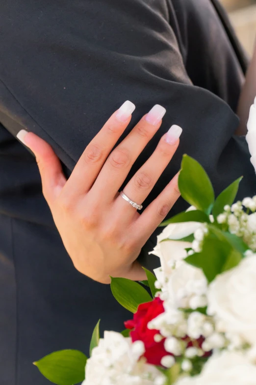 a close up of a person with wedding rings on her finger