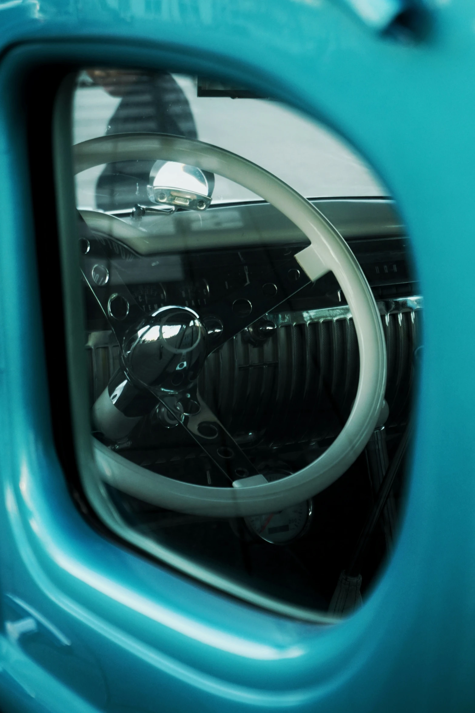 a car has a steering wheel and a light blue frame